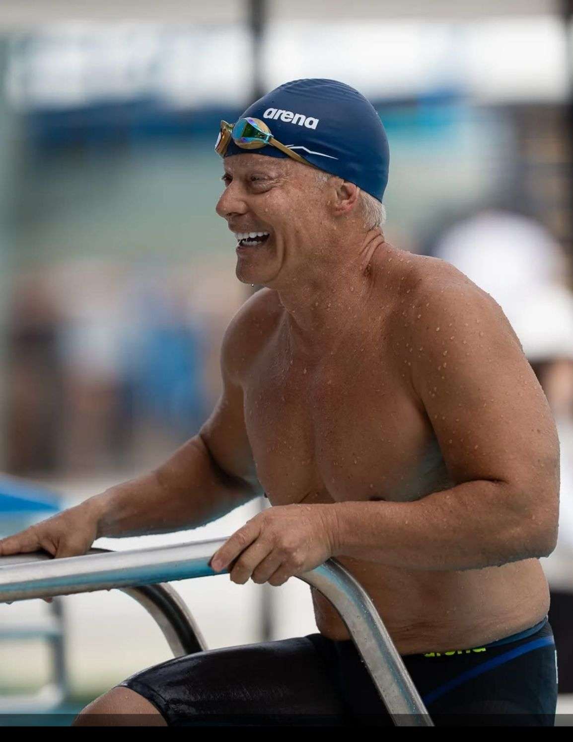 Daniel at pool laughing in swim gear